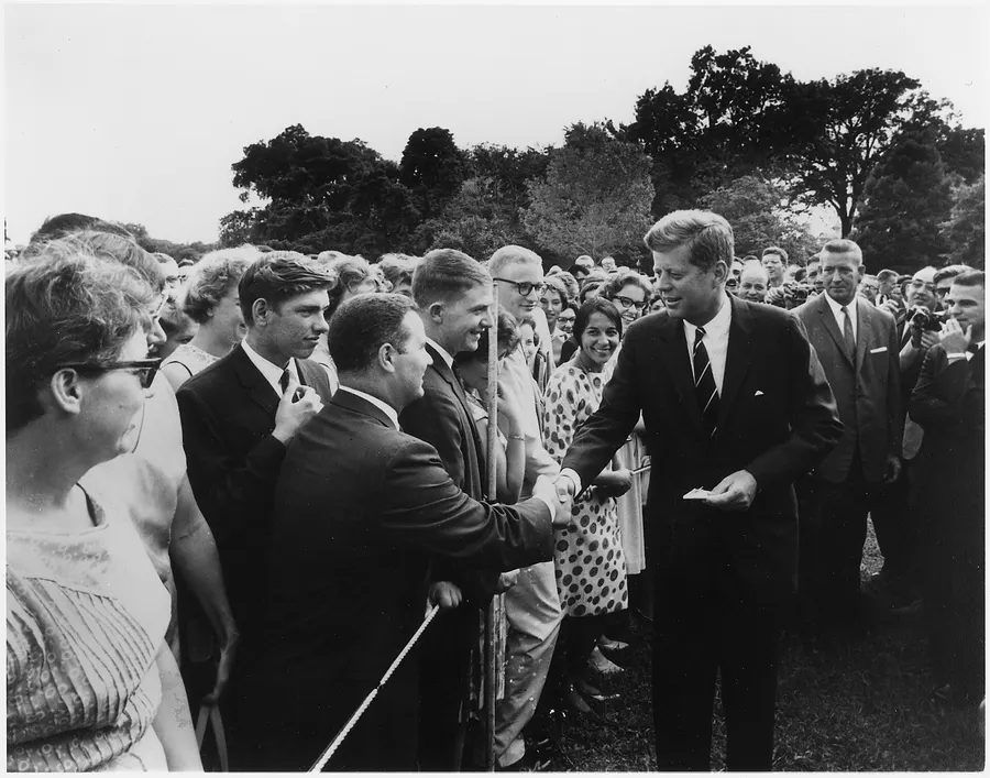President Kennedy greets Peace Corps volunteers at the White House, August 1962.