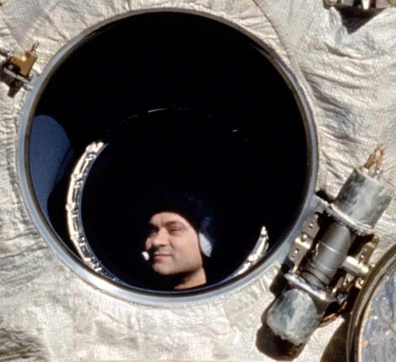 Valeri Polyakov looks out of a window of the Mir space station as the space shuttle Discovery approaches, February 1995.