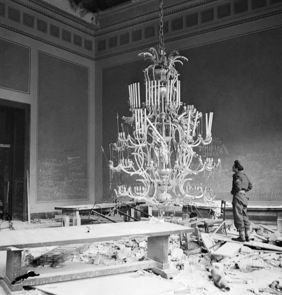 A British army photographer in the ruins of the Reich Chancellery in Berlin, July 1945.