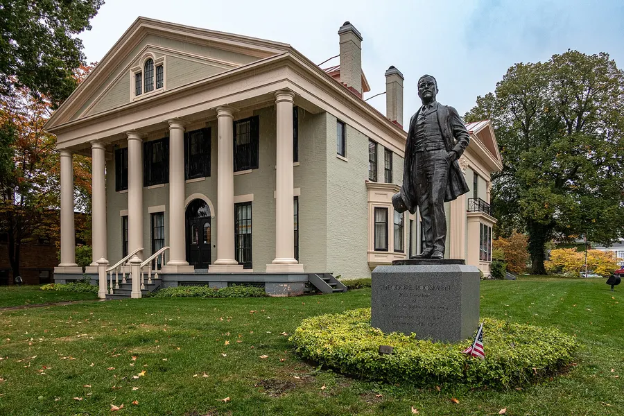 The Ansley Wilcox house in Buffalo, New York, where Roosevelt was sworn in, now the Theodore Roosevelt Inaugural National Historic Site, with a statue of him in front