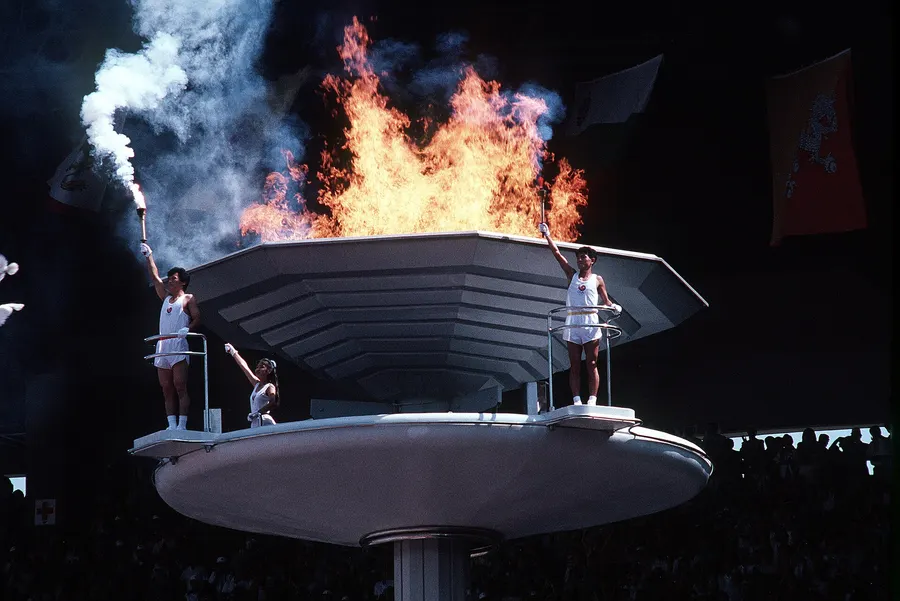 The ceremonial flame of the Seoul Olympic Games is lit by three young South Koreans, an athlete, a teacher and a dance student