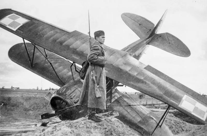 A Red Army soldier guards a Polish training aircraft brought down near Równe, in the part of Poland occupied by the Soviet Union in 1939