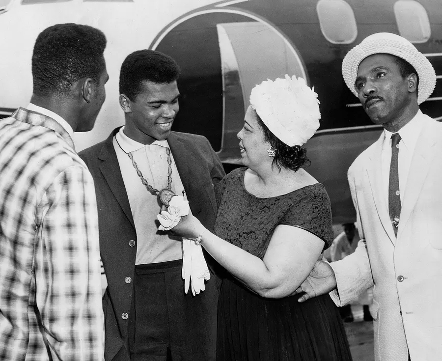 Cassius Clay with his family at Standiford Field airport in Louisville, admiring the gold medal he won at the Rome Olympics, September 1960