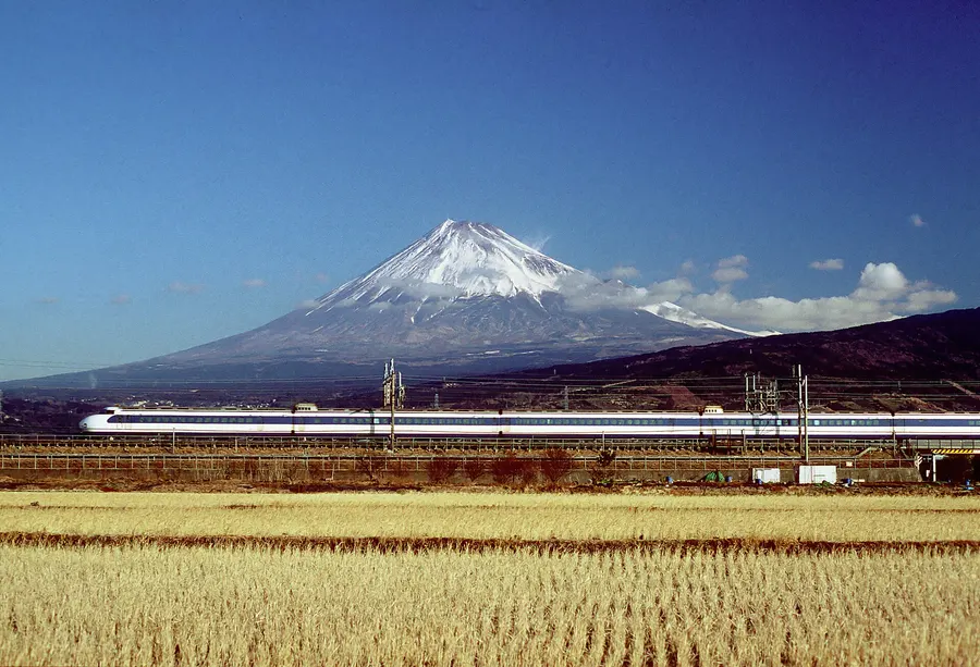 An original 0 Series bullet train passes Mount Fuji in 1999.