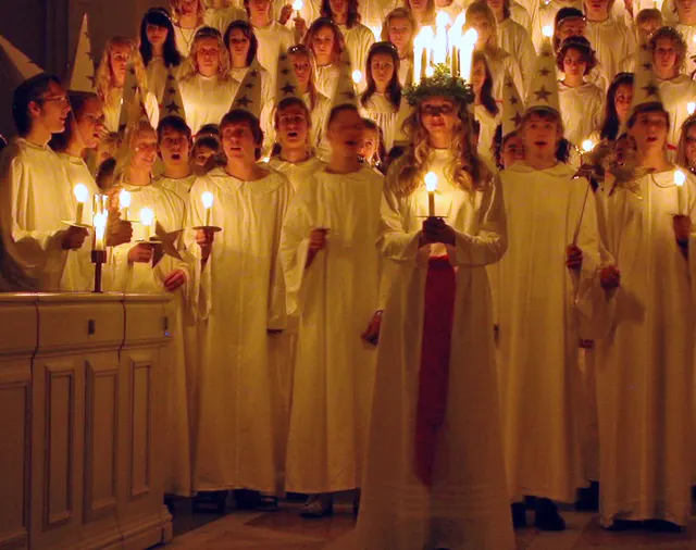 A Saint Lucy procession, with candles and white robes.