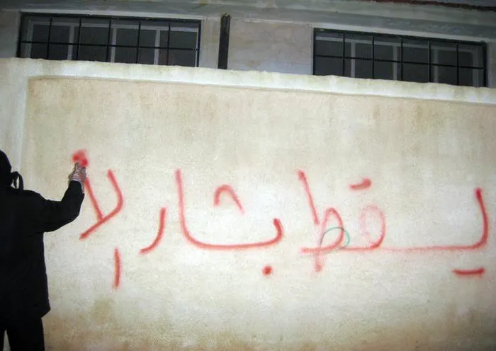 Graffiti reading 'Down with Bashar' on a wall in Syria, spring 2011.