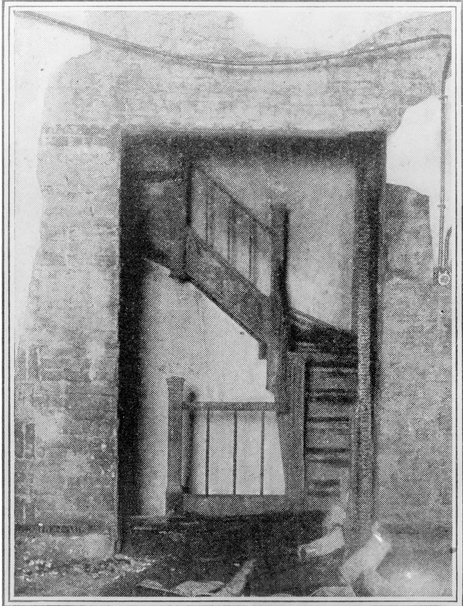 A newspaper photograph of an inside staircase of the Asch Building after the fire, 1911.