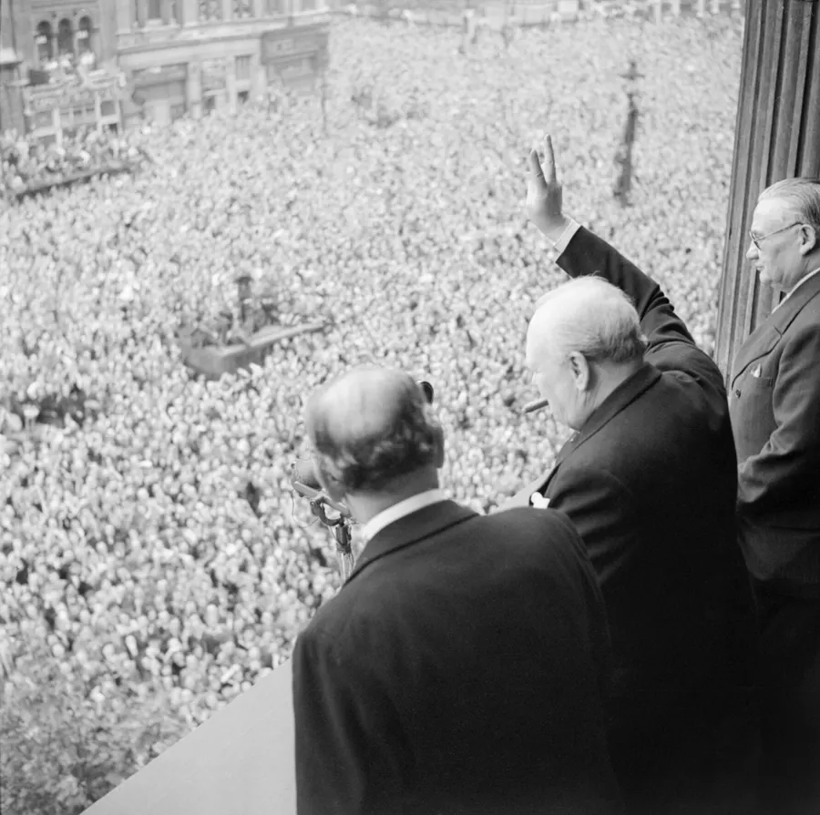 Winston Churchill waves to the crowds in Whitehall, London, on VE Day, 8 May 1945.