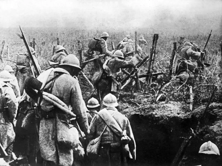 French soldiers leave their trench to attack during the Battle of Verdun, 1916.