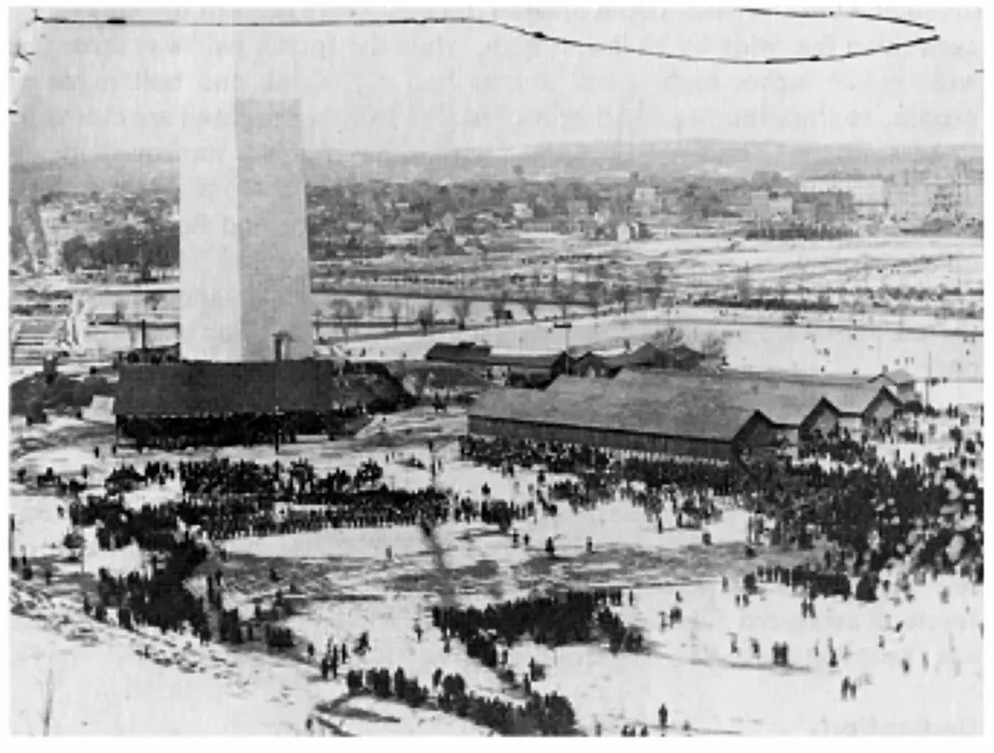 The dedication of the Washington Monument, 21 February 1885, with temporary buildings round its base.