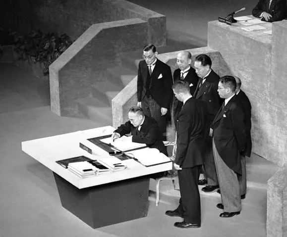 Prime Minister Shigeru Yoshida signs the peace treaty in San Francisco in September 1951; it took effect the following April.